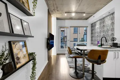 a kitchen and dining room with a table and chairs at Flat at the Foot of the Mountain With Parking in Montréal