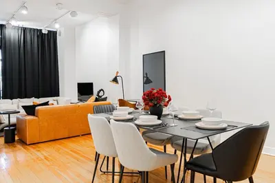 a living room with a table and chairs and a couch at Loft Spacieux Down Town in Montréal