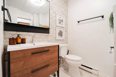 a bathroom with a white toilet and a sink at Loft Spacieux Down Town in Montréal