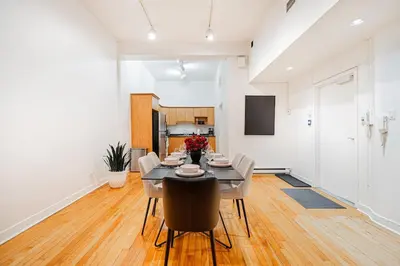 a kitchen and dining room with a table and chairs at Loft Spacieux Down Town in Montréal