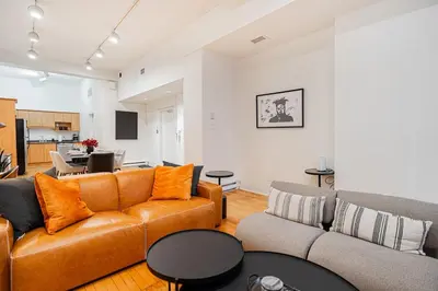 a living room with a couch and a table at Loft Spacieux Down Town in Montréal