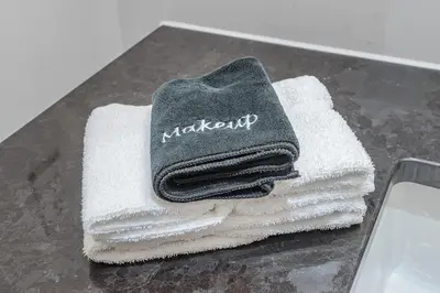 a pile of towels sitting on top of a table at Luxury Old Montreal Suite with Soaring Ceilings in Montréal
