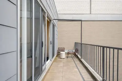 a balcony with two benches and a trash can at Luxury Old Montreal Suite with Soaring Ceilings in Montréal