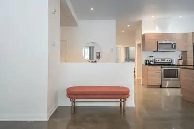 a room with a bench in the middle of a kitchen at Old Montreal Penthouse Iconic Location in Montréal