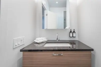 a bathroom with a sink and a mirror at Old Montreal Penthouse Iconic Location in Montréal