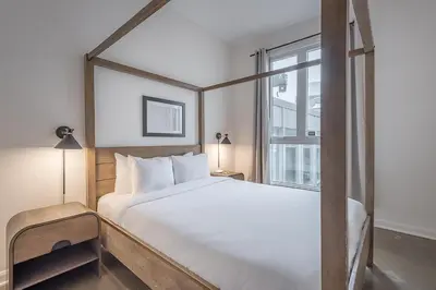 a bedroom with a large bed and a window at Old Montreal Penthouse Iconic Location in Montréal