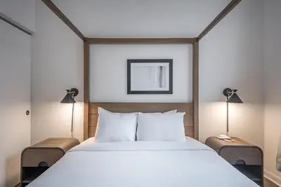a bedroom with a large bed with two lamps at Old Montreal Penthouse Iconic Location in Montréal