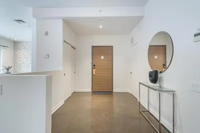 a hallway with a mirror and a door at Old Montreal Penthouse Iconic Location in Montréal