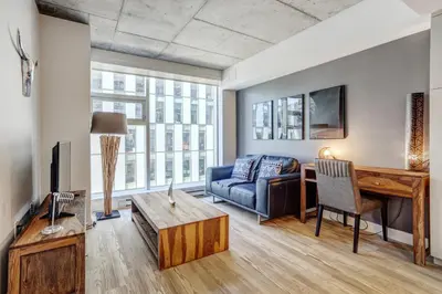 a living room with a couch and a table at Pet-Friendly Furnished 1B Rental in Montreal with Skyline Views & Concierge in Montréal
