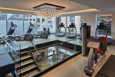 a gym with a glass counter with treadmills at Pet-Friendly Furnished 1B Rental in Montreal with Skyline Views & Concierge in Montréal