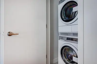 two washing machines sitting next to each other at Pet-Friendly Furnished 1B Rental in Montreal with Skyline Views & Concierge in Montréal