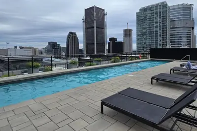 a swimming pool on the roof of a building at Pet-Friendly Furnished 1B Rental in Montreal with Skyline Views & Concierge in Montréal