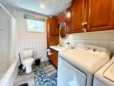 a small bathroom with a sink and a toilet at Waterfront with Spa - Le Retro in Windsor
