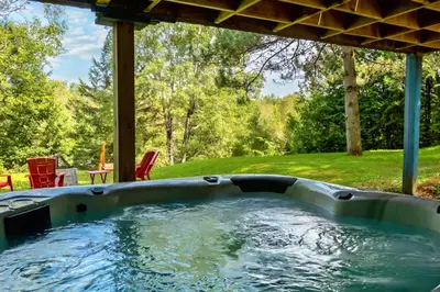 a plunge pool in a backyard with a hot tub at Waterfront with Spa - Le Retro in Windsor