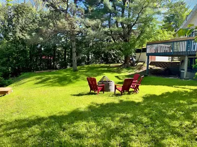a group of chairs sitting in the grass at Waterfront with Spa - Le Retro in Windsor