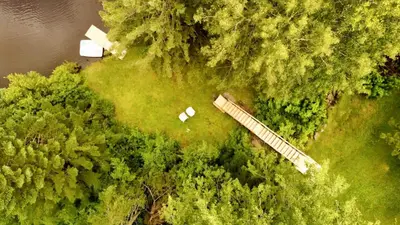an overhead view of a field with a house and trees at Waterfront with Spa - Le Retro in Windsor