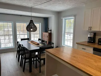 a kitchen with a table and chairs and a dining room at Lake Access - Private Spa - Pool table - Rustique in Windsor