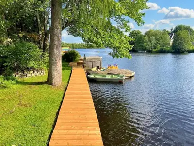 a dock with a boat on a lake at Lake Access - Private Spa - Pool table - Rustique in Windsor