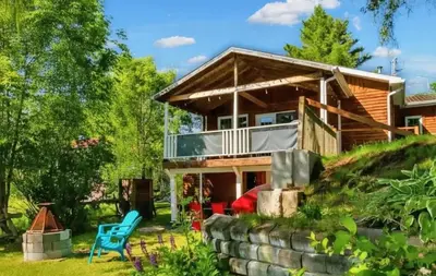 a log home with a wrap around porch at Lake Access - Private Spa - Pool table - Rustique in Windsor