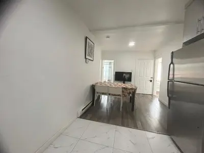 a dining room with a table and a refrigerator at Comfortable 4B Unit-Close to City Attractions in Montréal