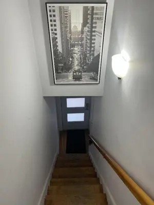 a stairway with a picture of a city at Montreal cozy entire apartment in Montréal
