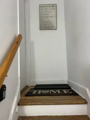 a stairwell with a welcome mat in a hallway at Montreal cozy entire apartment in Montréal