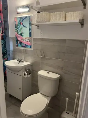 a bathroom with a white toilet and a sink at Montreal cozy entire apartment in Montréal