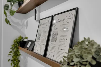 three framed menus on a wall with plants at Dreaming at the Base of the Mountain With Parking in Montréal