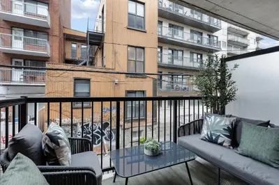 a balcony with a couch and a building at Dreaming at the Base of the Mountain With Parking in Montréal