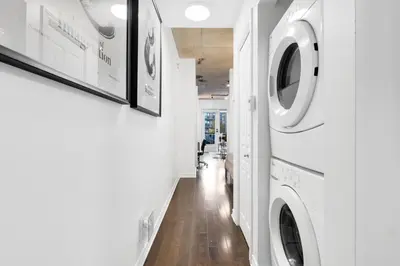 a hallway with a washer and dryer in a house at Pristine Parc Avenue Pad With Parking in Montréal