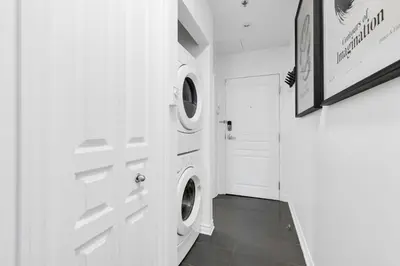a laundry room with two washer and dryer machines at Pristine Parc Avenue Pad With Parking in Montréal