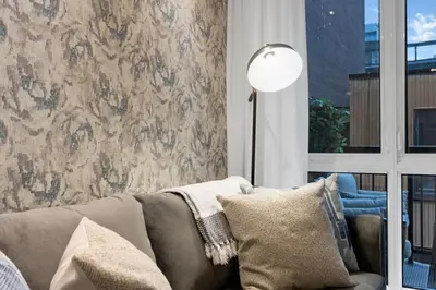 a living room with a couch and a floor lamp at Impeccable Parc Avenue Pad With Parking in Montréal