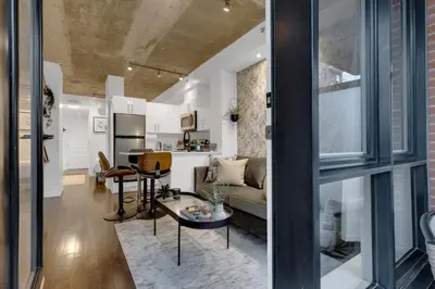 a living room with a couch and a table at Impeccable Parc Avenue Pad With Parking in Montréal