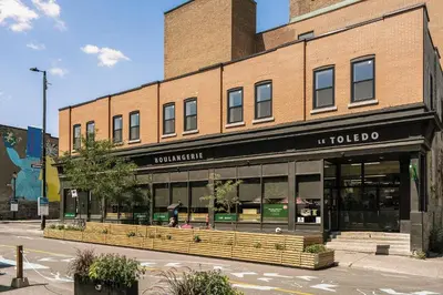 a store front of a brick building on a street at The Cove Hotel in Montréal