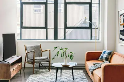 a living room with a couch and a table at The Cove Hotel in Montréal