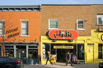 a building with a sign for a thrift store at The Cove Hotel in Montréal