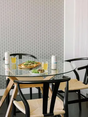 a glass table with two plates of food and drinks at The Cove Hotel in Montréal