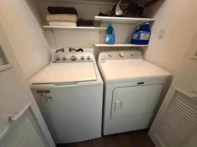 a small kitchen with a stove and a washer at Stunning & Serene Downtown Apartment in Montréal