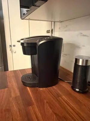a black mixer sitting on top of a wooden floor at Stunning & Serene Downtown Apartment in Montréal