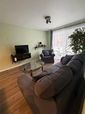 a living room with a couch and a glass table at Stunning & Serene Downtown Apartment in Montréal