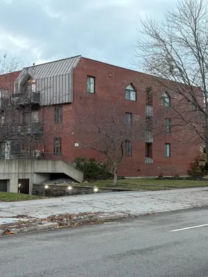a large red brick building on the side of a street at Stunning & Serene Downtown Apartment in Montréal