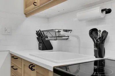 a kitchen counter with a sink and utensils at The Sherbrooke Suite 101 in Montréal