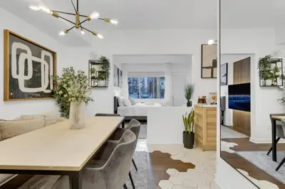 a dining room and living room with a table and chairs at The Sherbrooke Suite 101 in Montréal