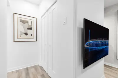 a hallway with a tv on a wall at The Sherbrooke Suite in Montréal