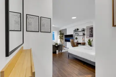 a bedroom with a bed and a living room at The Sherbrooke Suite 105 in Montréal