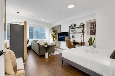 a bedroom with a bed and a living room at The Sherbrooke Suite 105 in Montréal