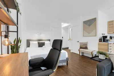 a bedroom with a bed and a desk and a chair at The Sherbrooke Suite 105 in Montréal