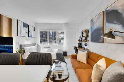 a living room with a bed and a couch at The Sherbrooke Suite 99 in Montréal