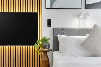 a bedroom with a bed and a table with a plant at The Sherbrooke Suite 99 in Montréal