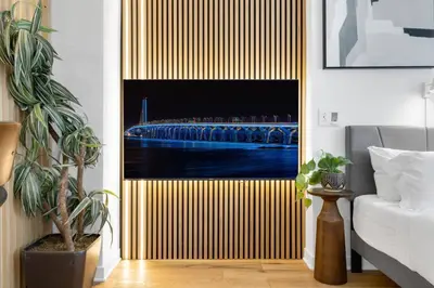 a bedroom with a sliding door with a painting of a ship at The Sherbrooke Suite 99 in Montréal